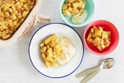 French toast casserole in various bowls with yogurt.