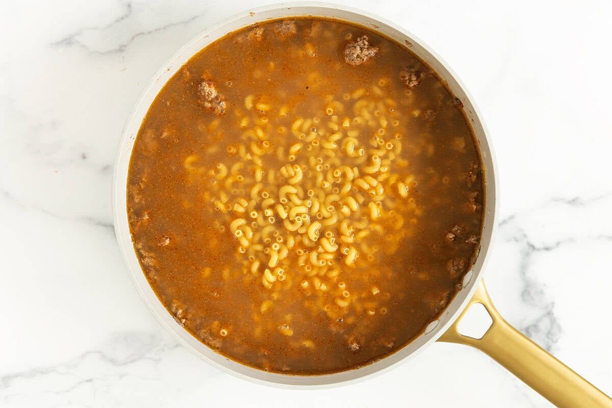 Hamburger helper being made in pan.