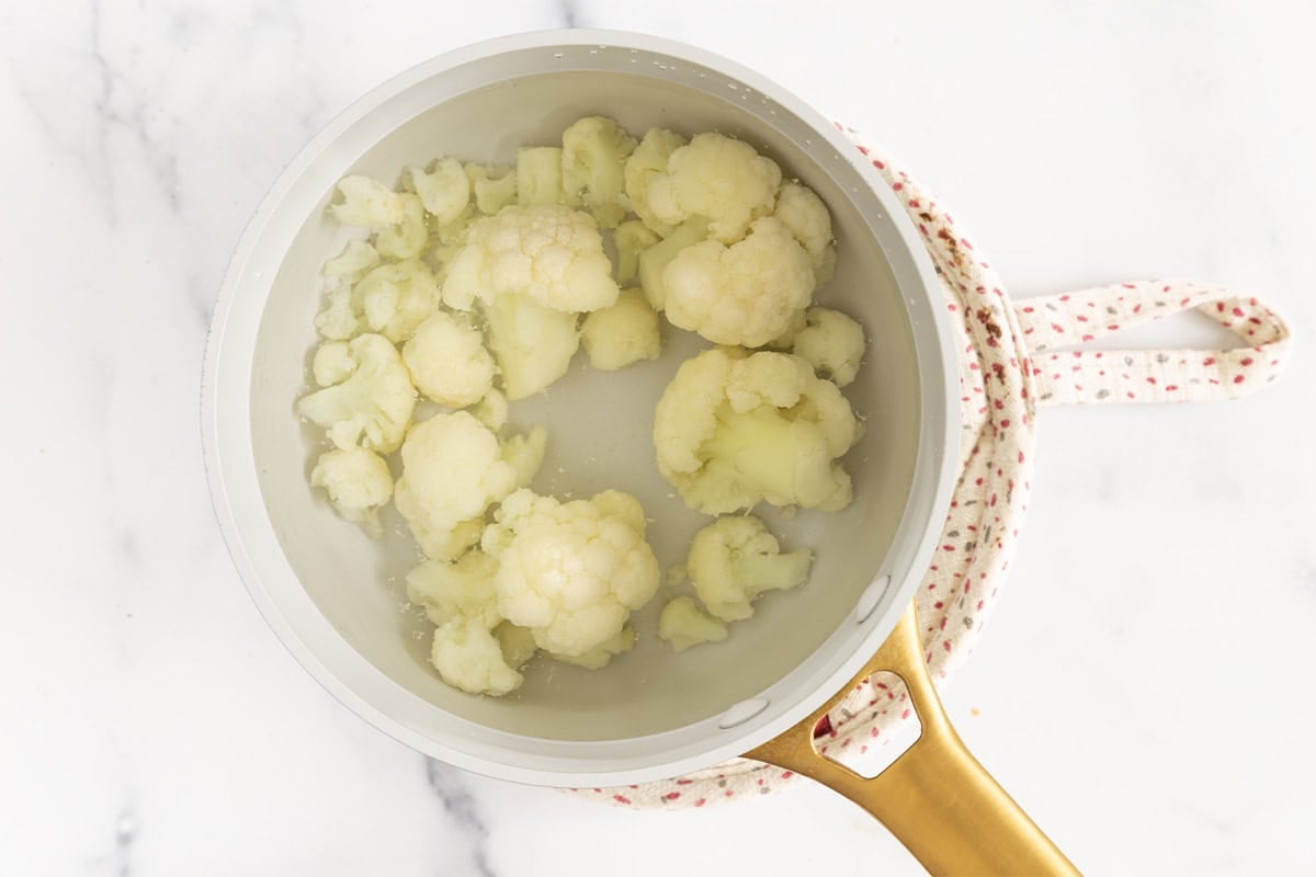 Cauliflower in pot for creamy chicken pasta.