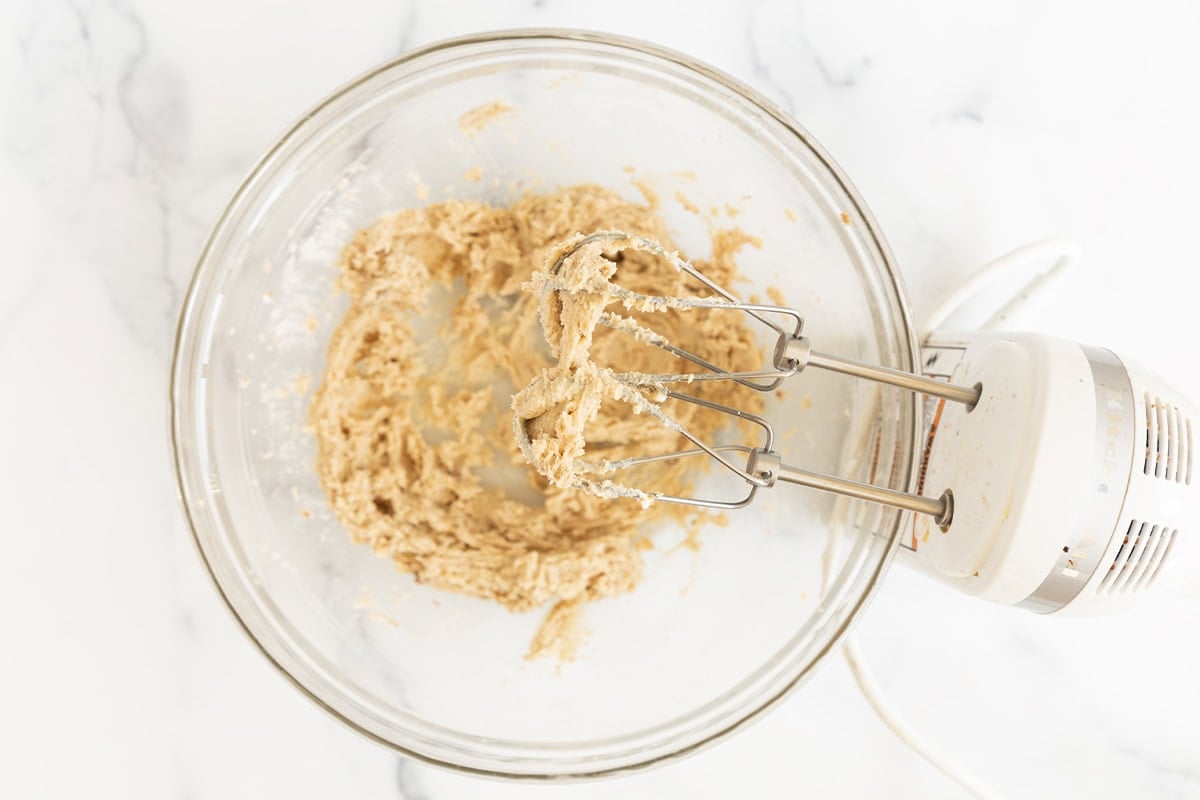 Creaming butter and sugar together in glass bowl for monster cookies. 