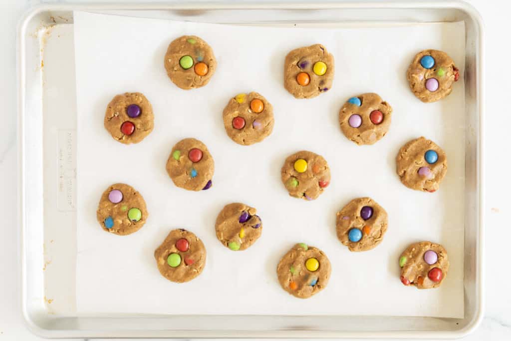 Monster cookies on baking sheet before baking.