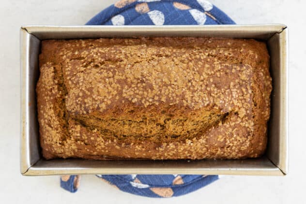pumpkin banana bread loaf on pot holder.