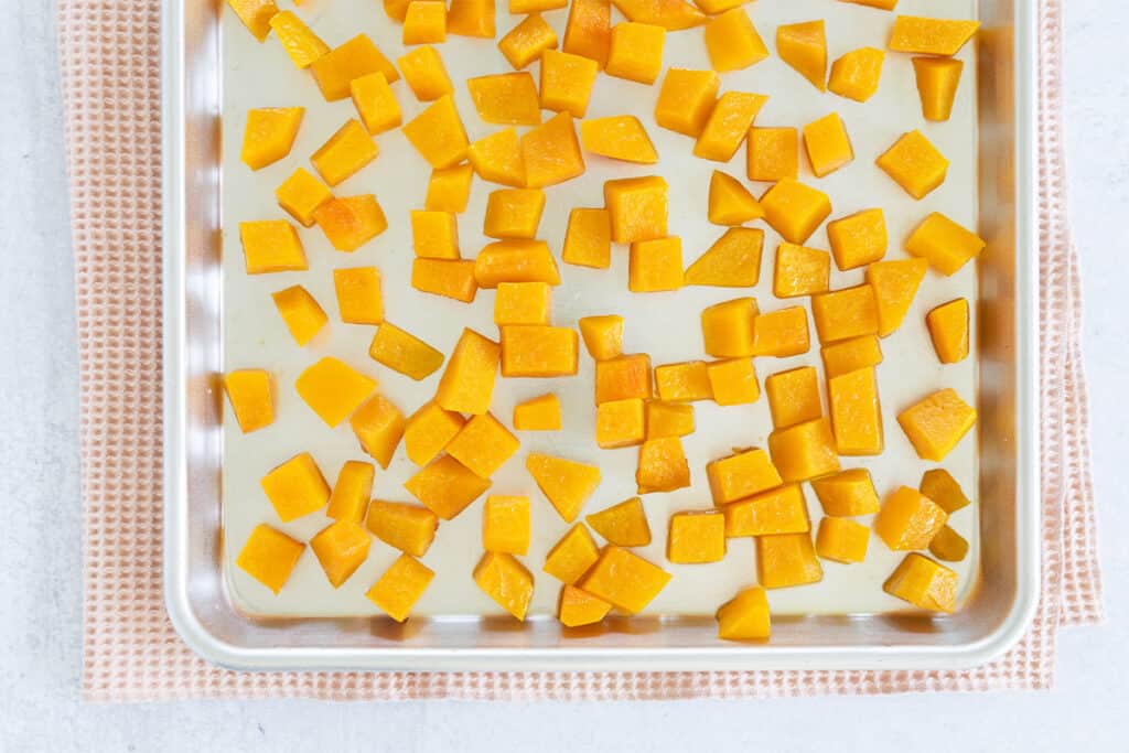 cubes of roasted butternut squash on baking pan.