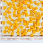 cubes of roasted butternut squash on baking pan.