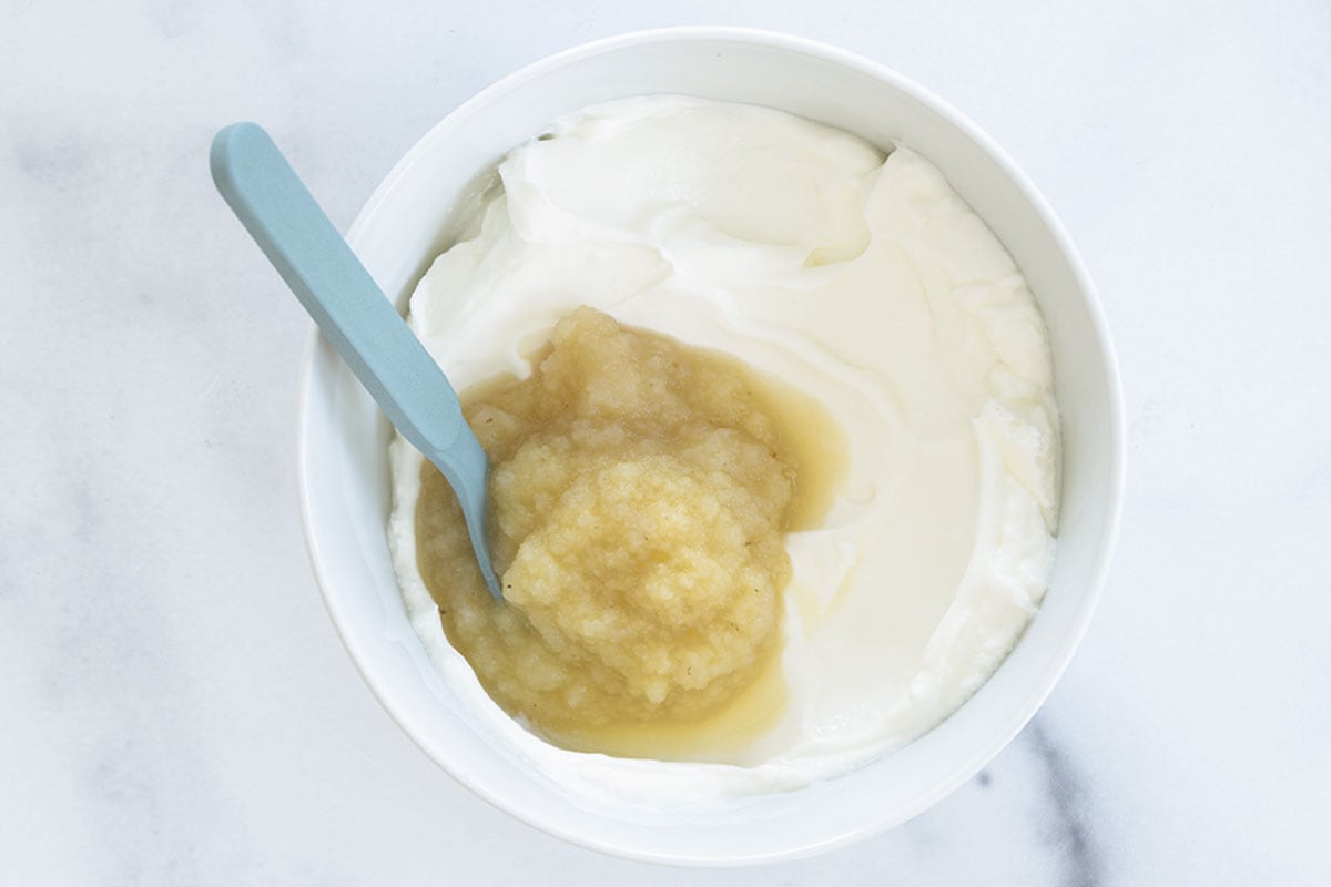 yogurt and applesauce in white bowl.