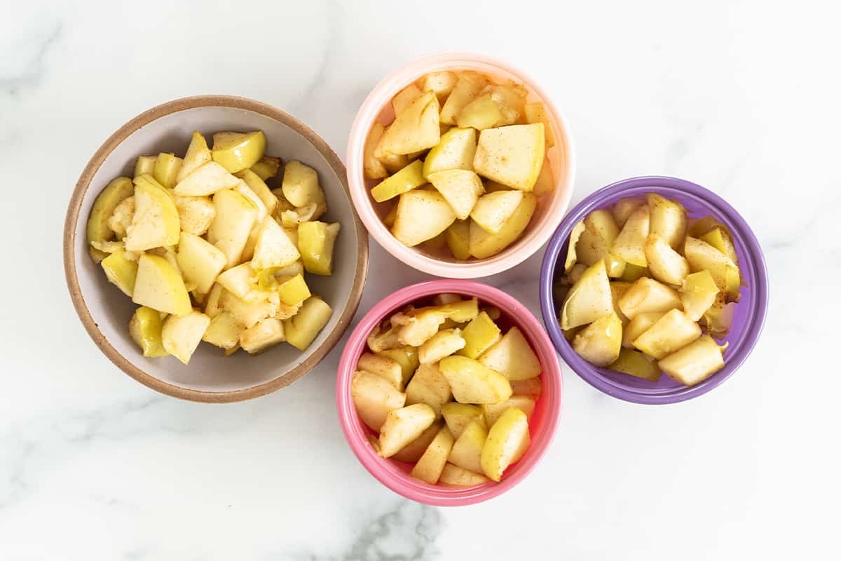 Air fryer apples in four bowls.