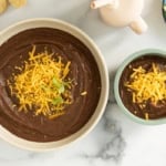 Black bean soup in two bowls with toppings.