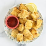 Fish nuggets on plate with dipping sauce.