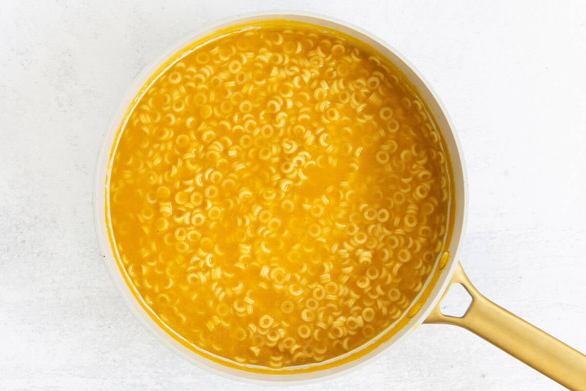 Pot full of pasta in broth.