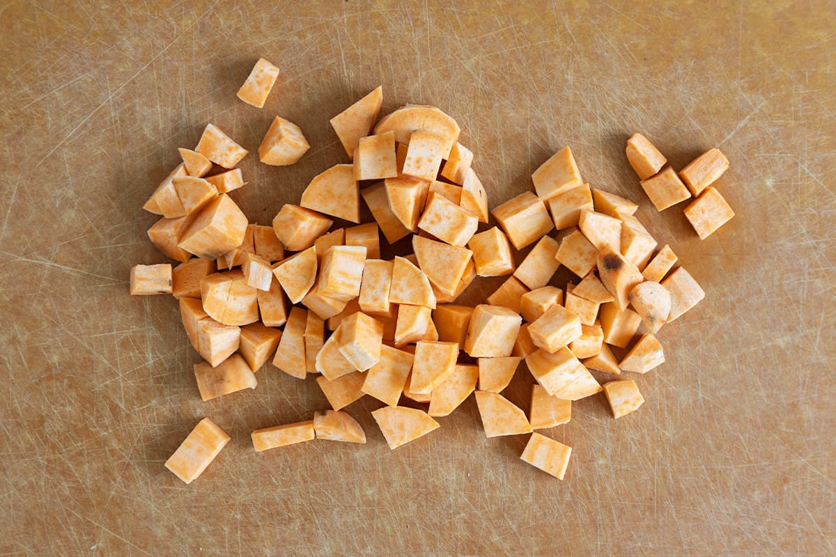 Chopped sweet potatoes on cutting board for sweet potato tots.