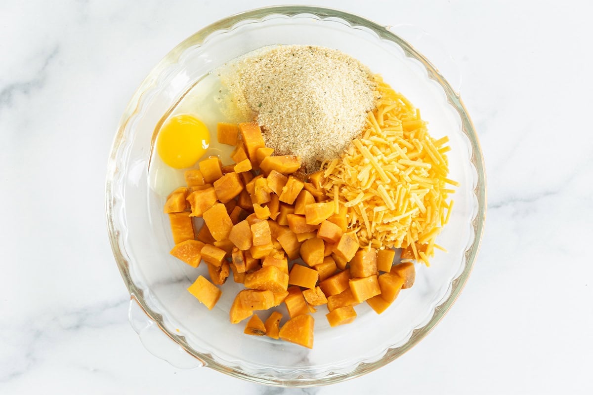 Ingredients for sweet potato tots in glass dish before mixing.