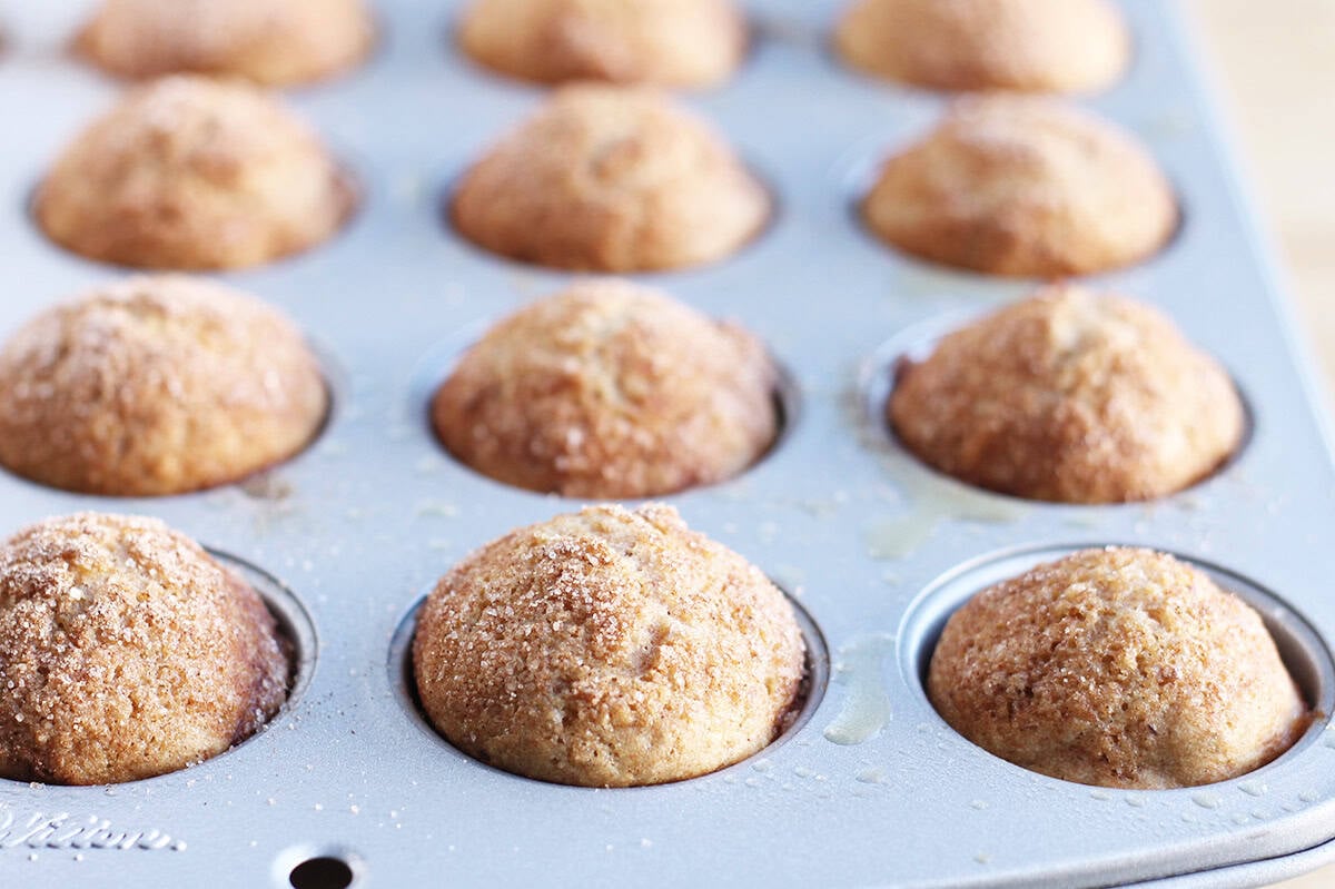 baked cinnamon muffins in muffin pan.