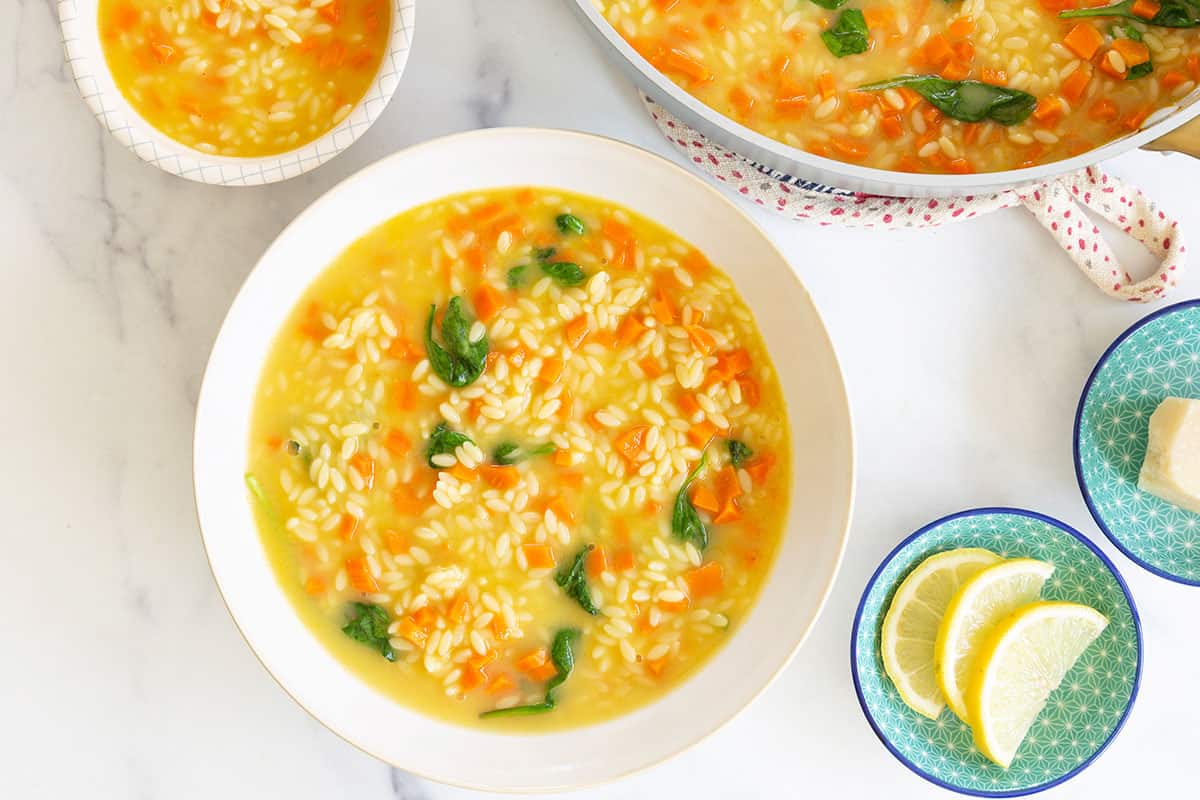 orzo soup in bowls on counter.