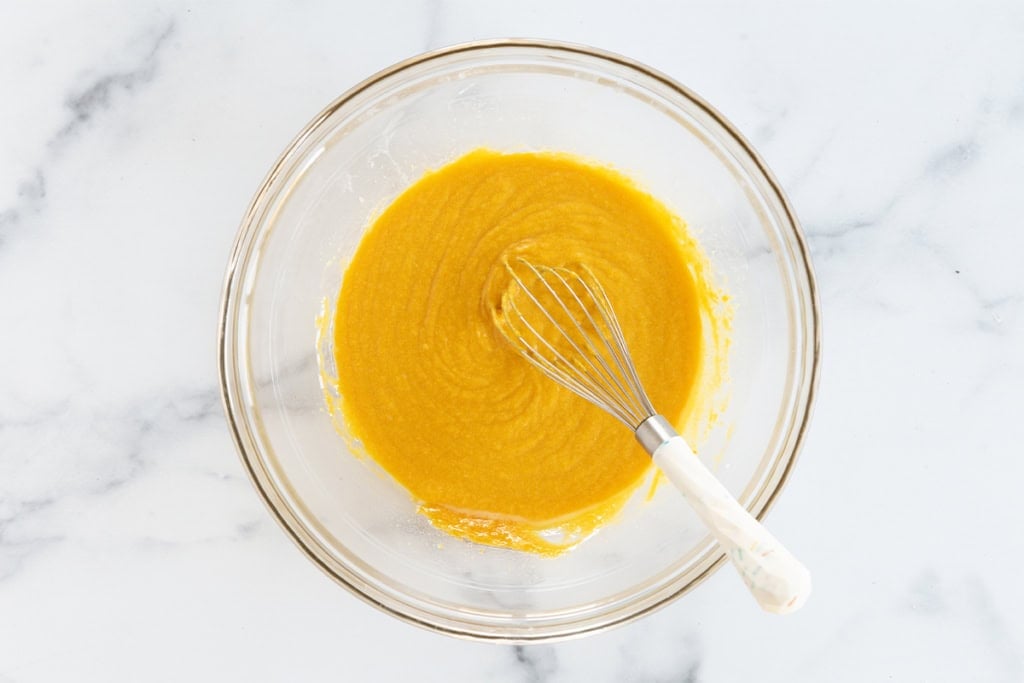 Batter for pumpkin muffins in glass bowl.