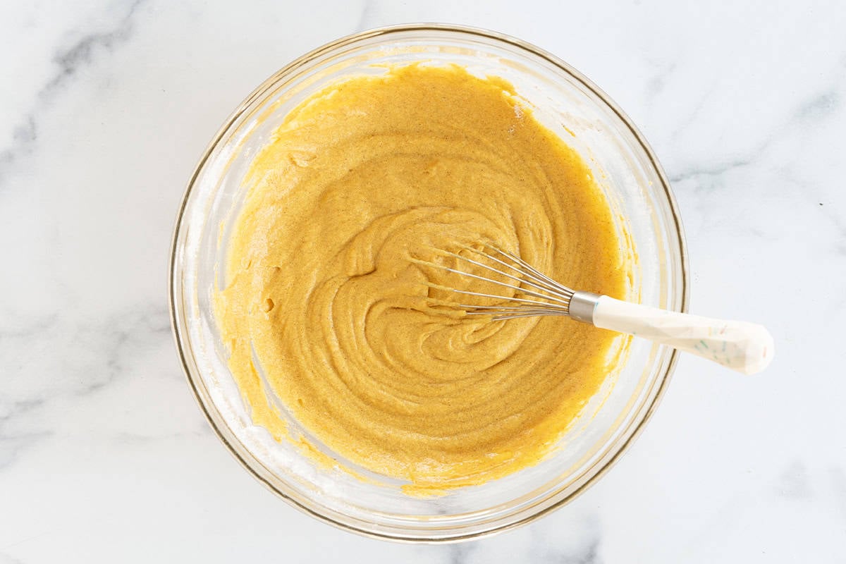 Batter for pumpkin muffins in glass bowl.