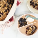 Blueberry baked oatmeal on two plates and in pan.