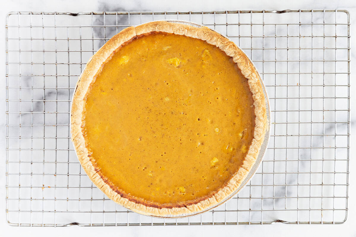 Pumpkin pie on cooling rack.
