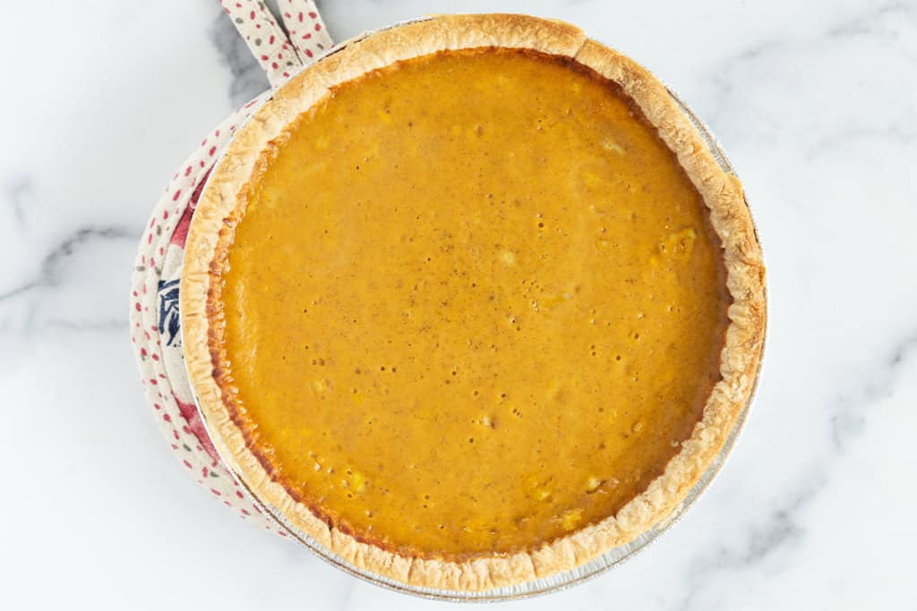 Pumpkin pie on countertop.