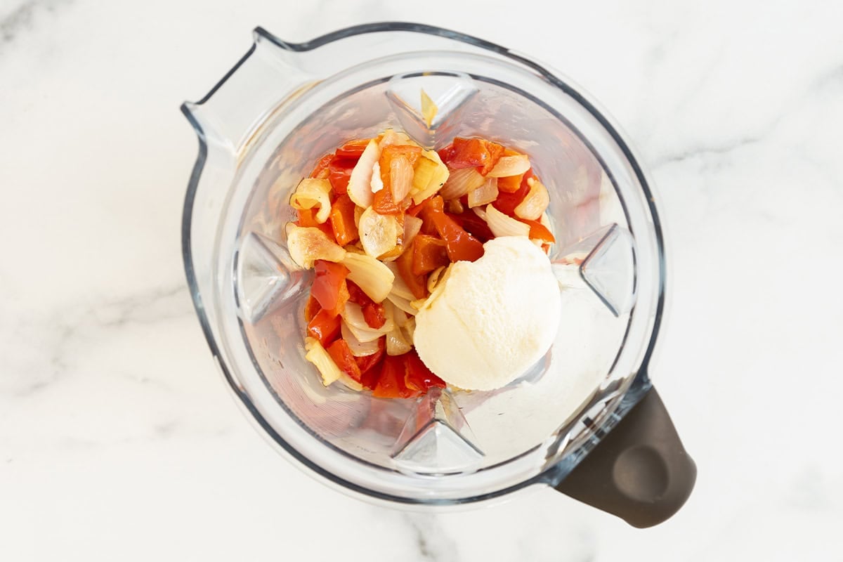 Red pepper pasta ingredients in blender before blending.
