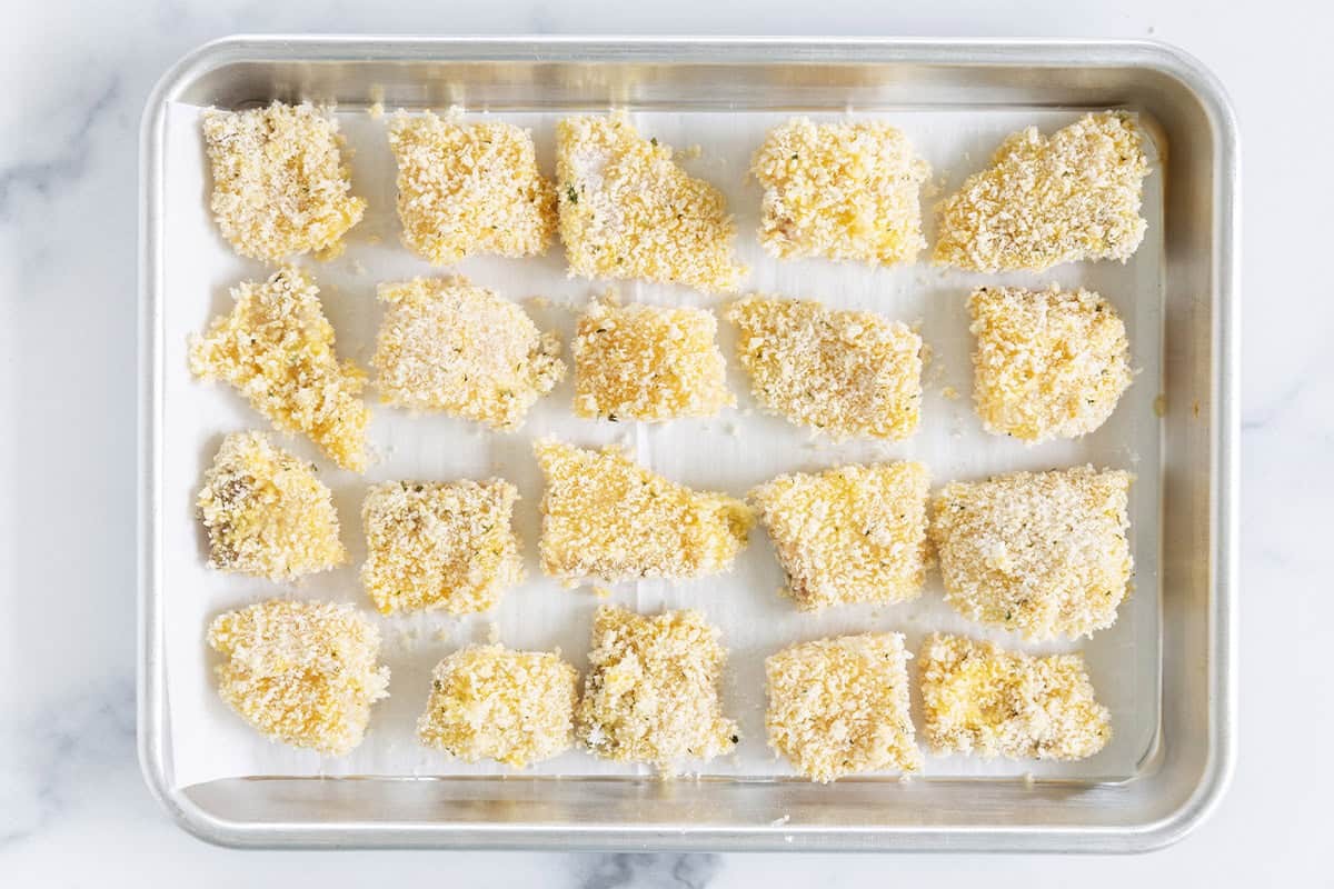 Fish nuggets on baking sheet before baking.