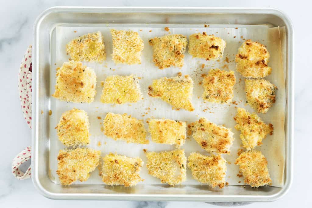 Fish nuggets on baking sheet.