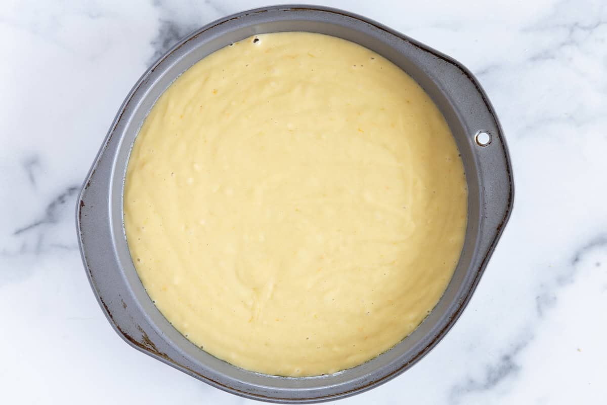 Olive oil cake in baking pan before baking.