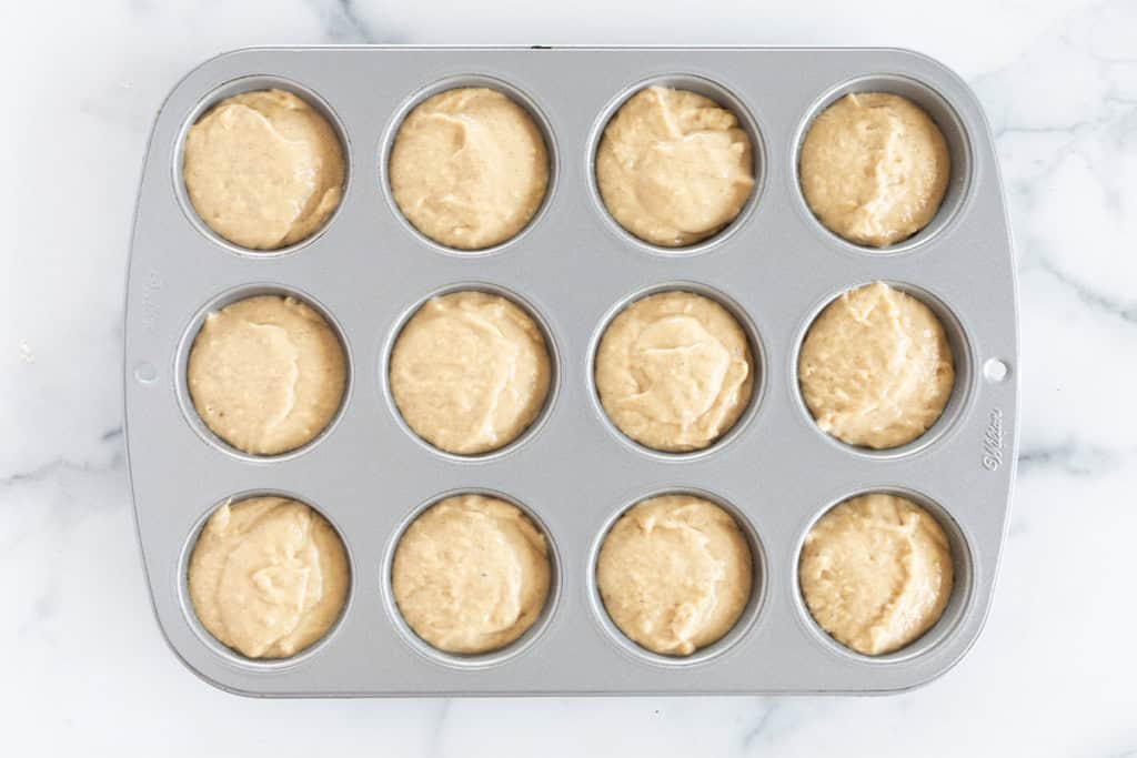 protein banana muffins in muffin pan before baking. 