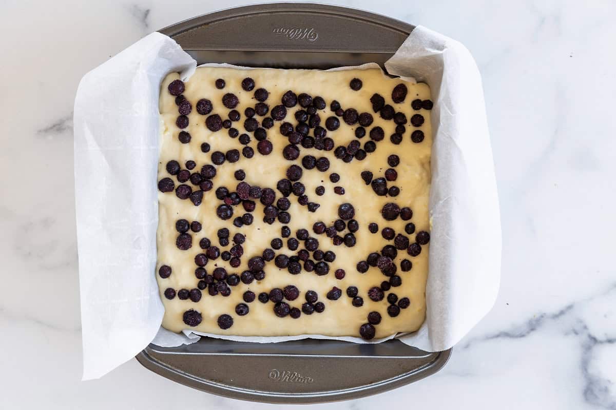 Blueberry yogurt cake in baking pan before baking.