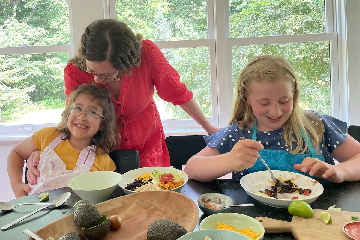 Mom with kids eating dinner.