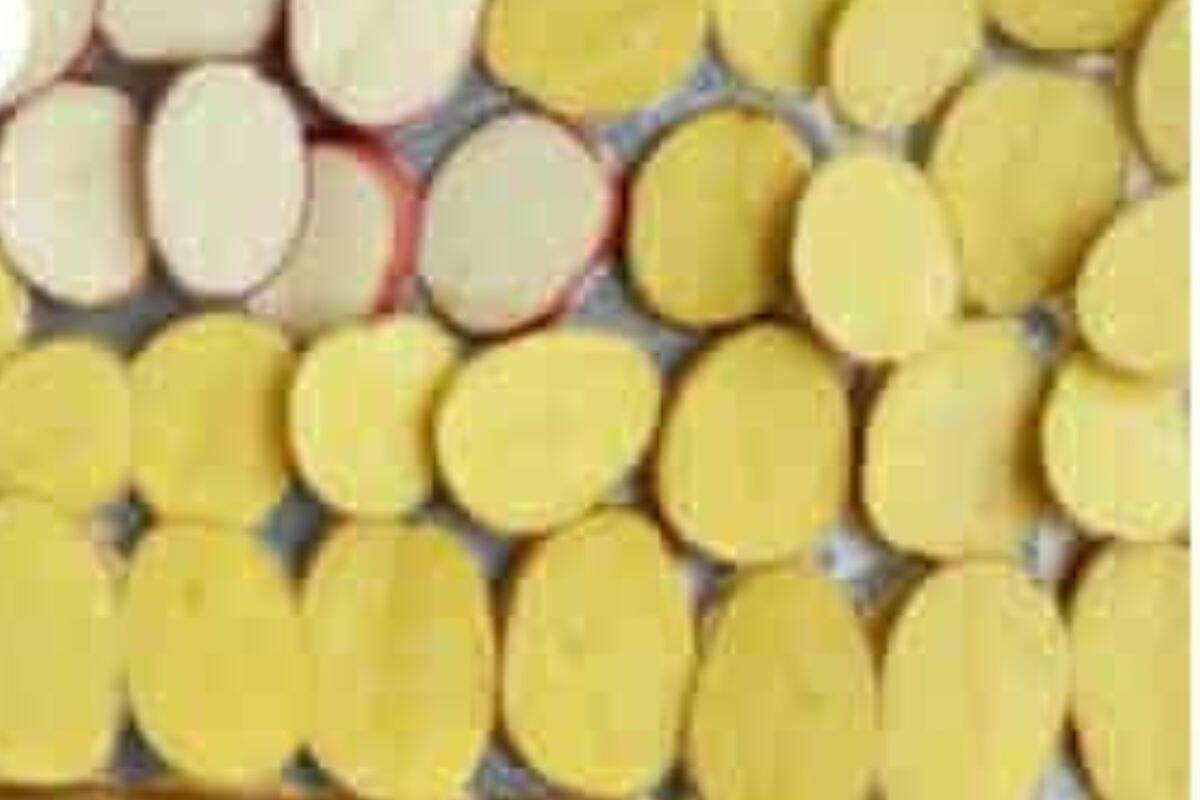 Slices of potato on sheet pan for baked nachos. 