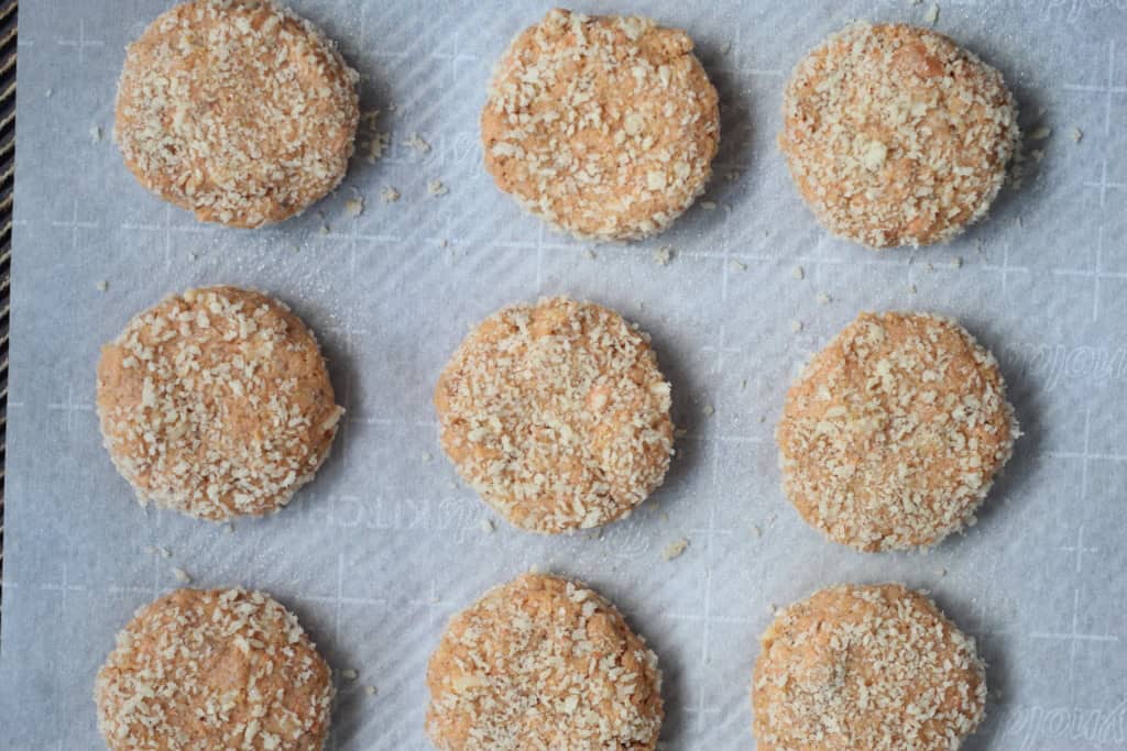 Baked salmon cakes on baking sheet.