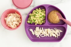 Chicken for baby on purple plate with sides.