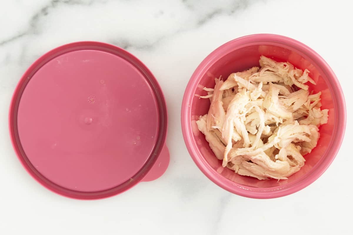 Leftover chicken in pink tupperware container.