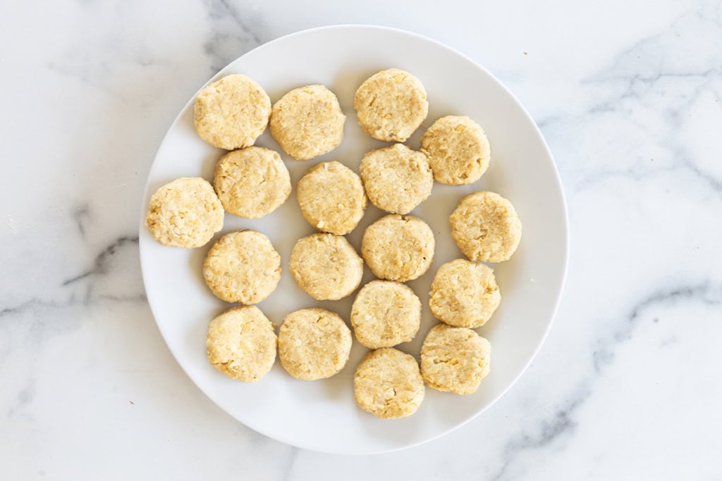 Chickpea fritters on plate before cooking.