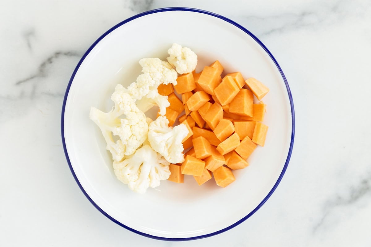 Veggies in white bowl for hidden veggie mac and cheese. 