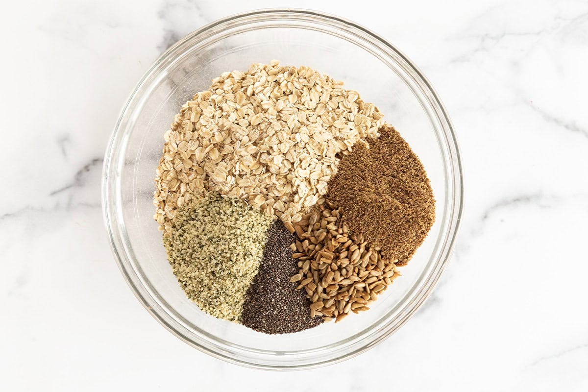 Ingredients for nut free granola in glass bowl.
