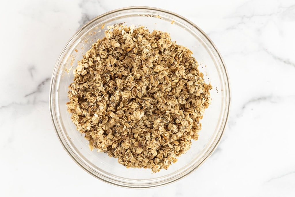 Nut free granola in glass bowl before baking.
