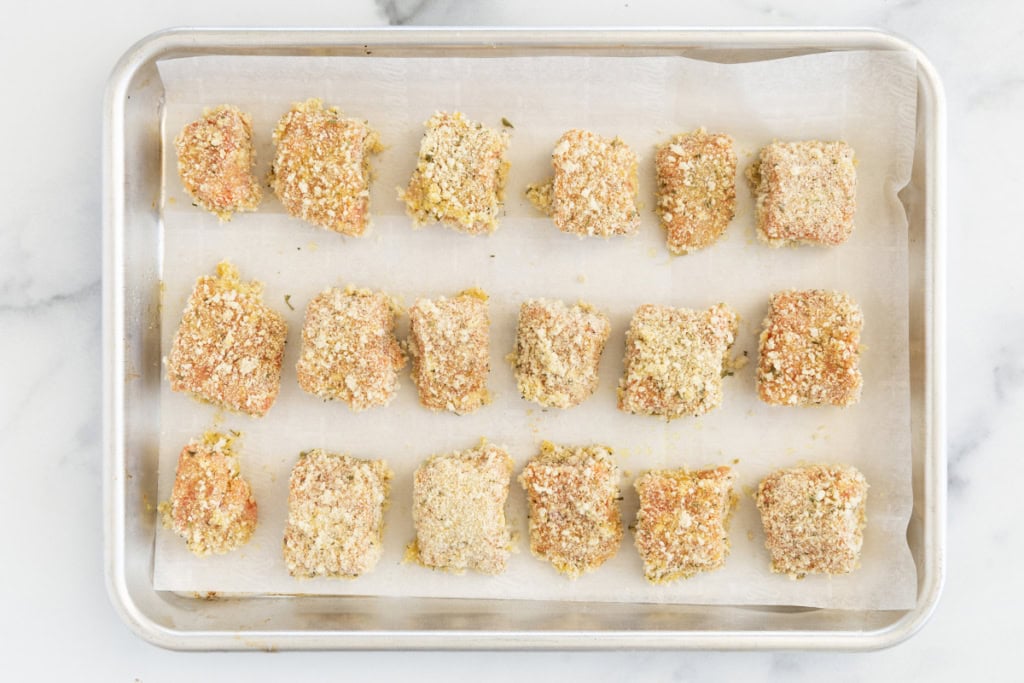 Salmon nuggets on baking sheet before baking.