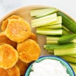 chickpea fritters on plate with cucumbers.