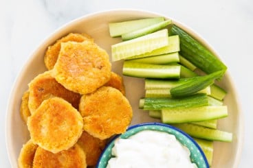 chickpea fritters on plate with cucumbers.