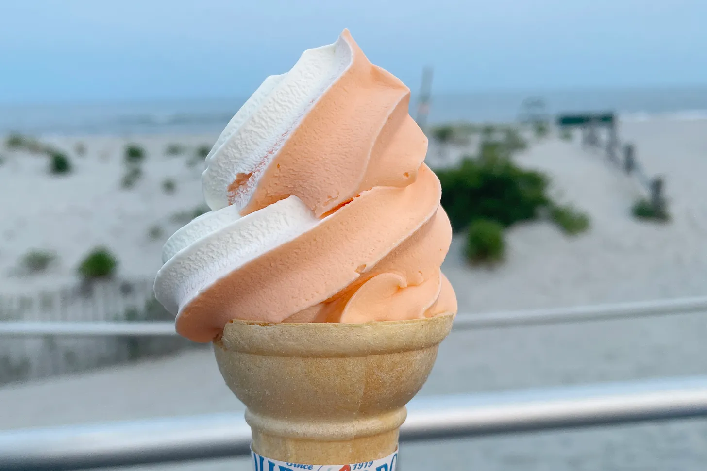 Ice cream cone in front of beach.