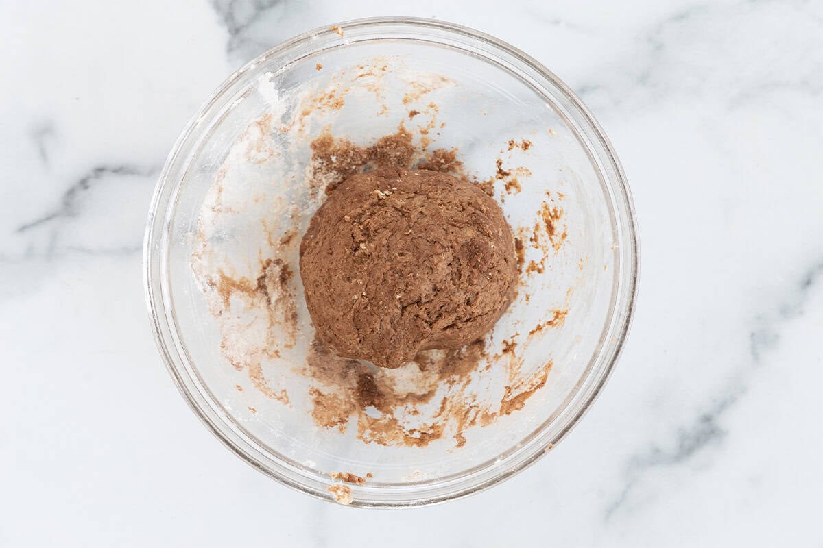Dough for chocolate sugar cookies in glass bowl.