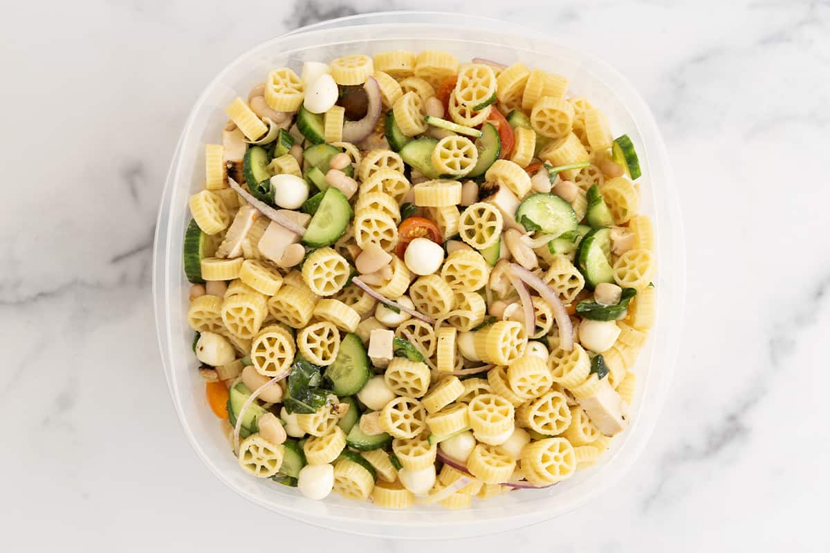 pasta salad ready to store in tupperware container.