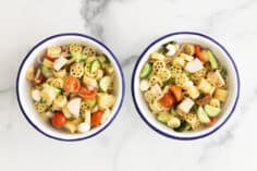 two bowls of pasta salad with chicken.