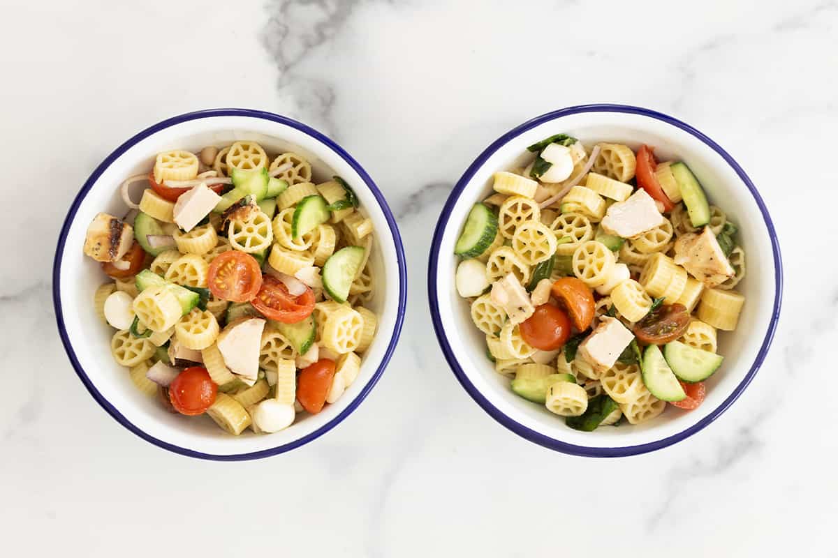 two bowls of pasta salad with chicken.