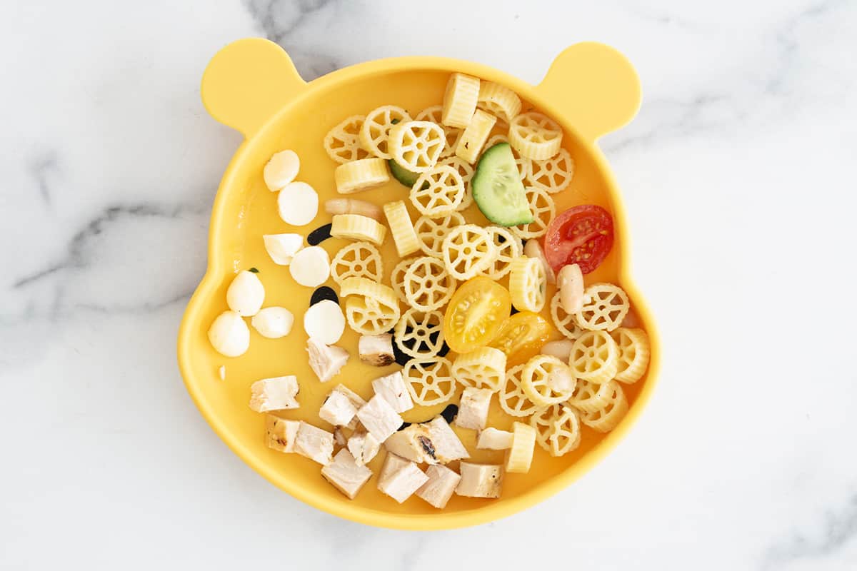 pasta salad on a kids' silicone plate.