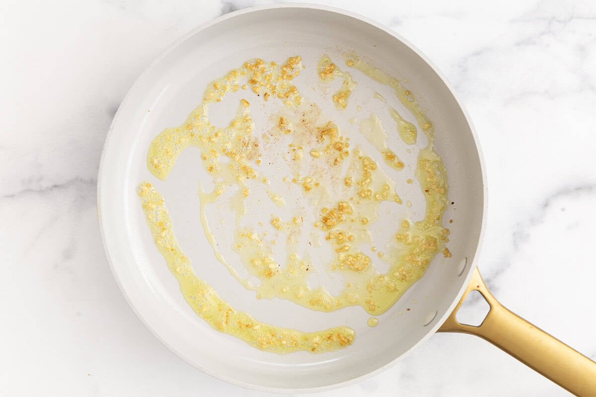 Garlic and oil in pan for spinach pasta sauce. 