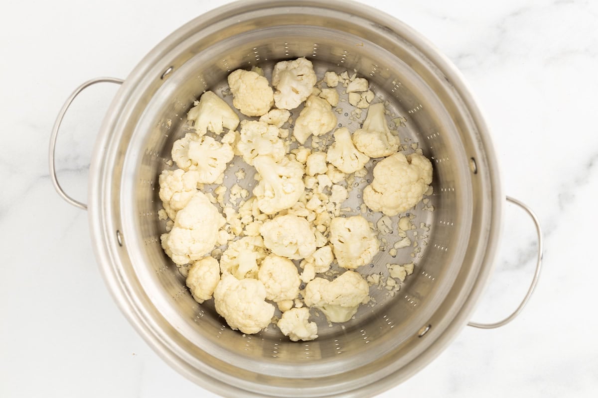 Cauliflower pieces in steamer before steaming.