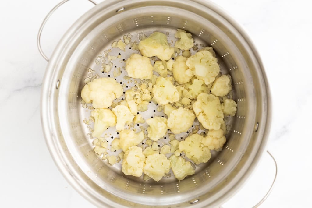 Steamed cauliflower in steamer after steaming.