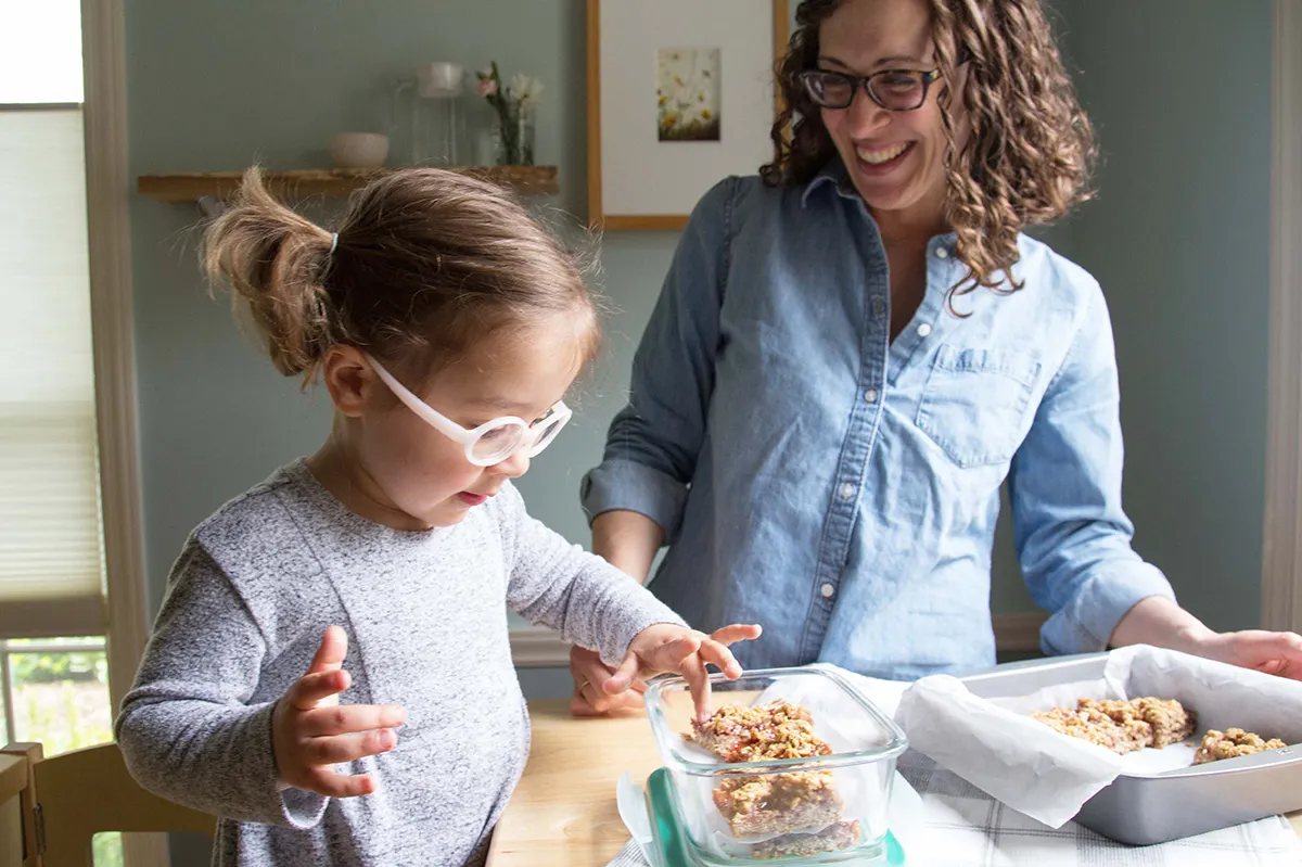 Mom and daughter at kitchen counter.